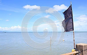 Black flag with blue sky sea