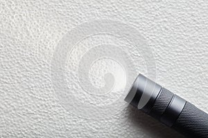 Black flashlight with a beam of light on White background