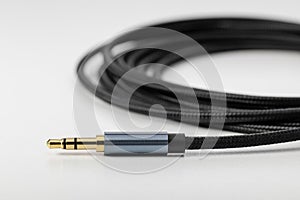Black flexible audio cable with plug for connecting electronics.