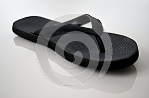 Black flip flop on white background