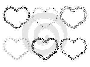 Black floral frames in the shape of a heart. Vector border decoration elements. Stock illustration