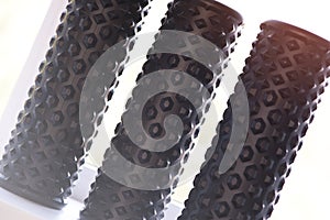 A black foam massage roller