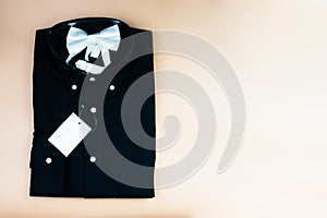 Black folded mens shirt with blank tag label mockup and white bow tie