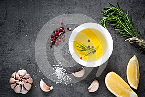 Black food background with olive oil and spices