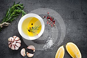 Black food background with olive oil and spices