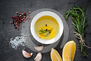 Black food background with olive oil and spices