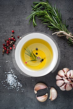 Black food background with olive oil and spices