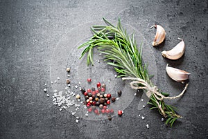 Black food background with olive oil and spices