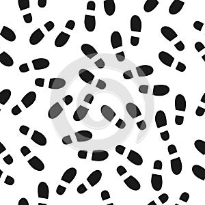 Black footprints seamless pattern white background. Footsteps silhouette
