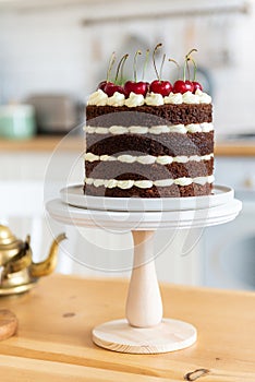 Black forest cake, Schwarzwalder Kirschtorte, Schwarzwald pie, dark chocolate and cherry dessert on wooden background. Bakery