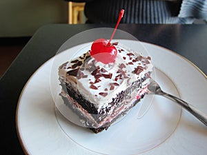 Black forest chocolate cake slice on a plate sweet pie treat dessert pastry