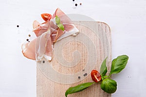 Black forest ham on wooden cutting board