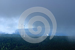 Black Forest landscape and wind turbines covered in fog