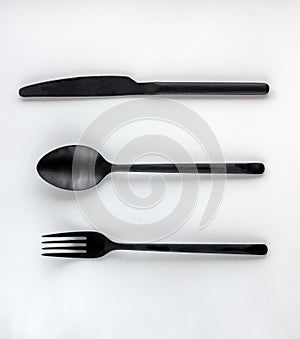 Black fork, spoon, knife isolated on white