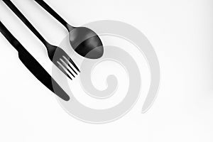 Black fork, spoon, knife isolated on white