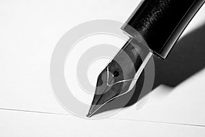 Black fountain pen with silver nib isolated on white