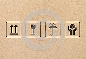 Black fragile sign and symbol on brown cardboard paper.