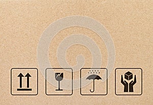 Black fragile sign and symbol on brown cardboard paper.