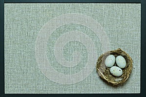 Black frame with beige background with nest and eggs, can be a wish for Happy Easter