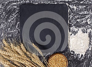 Black frame with wheat ears of wheat and flour