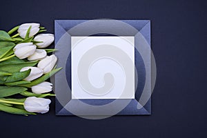 Black frame with white background and a bouquet of white tulips on the left side