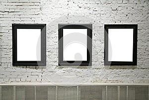 Black frames on white brick wall