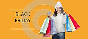 Black Friday. African american woman holding credit card and bags