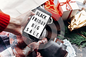 Black friday big sale special offer. woman holding phone with di