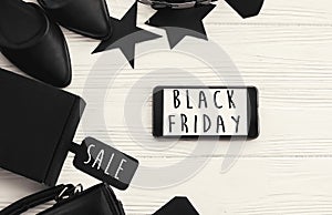 Black Friday big sale text on phone screen. Special discount christmas offer. Phone with advertising message at gift boxes and pr