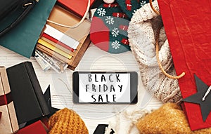 Black Friday big sale text on phone screen. Special discount christmas offer. Phone with advertising message at money, wallet, ba