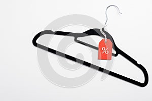 Black Friday sale banner. Coathanger with red tag on white background. Special offer, discount in clothes store concept