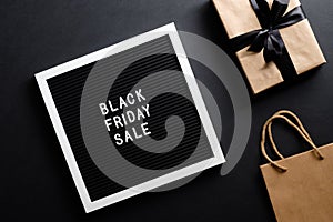 Black Friday sale concept. Letter board with sign `Black Friday sale`,shopping bag and gift box over black background. Flat lay, t