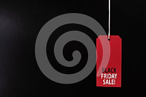 Black Friday sale concept. Red Sale tag color on the black background with Copy space.Black Friday weekend