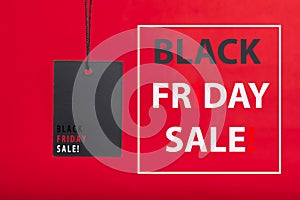 Black Friday sale concepts. Black Sale tag color on the red background with Copy space