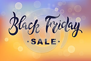 Black Friday sale lettering on sunset abstract background with bokeh.