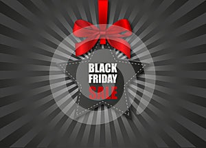 Black friday sale poster. star-shaped price tag with red bow on black sunburst background