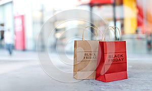 Black Friday sale shopping bags on floor front of mall