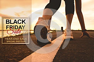 Black Friday Sale, sport runner start running on sunset - focus on shoe