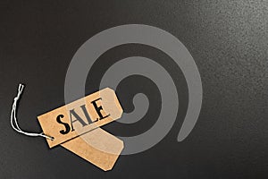 Black Friday. Sale tags on the black background. Zero waste shopping concept