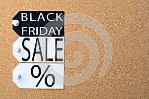 Black Friday sale tags are pinned to the cork board