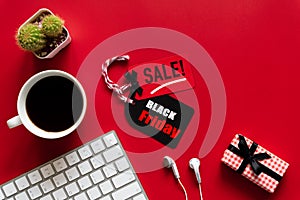 Black Friday Sale text on a red and black tag with coffee cup