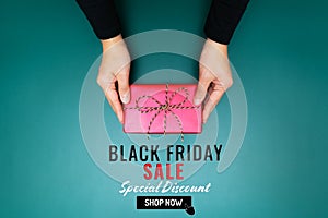 Black Friday Sale, young woman hand with a gift box offer to receiver