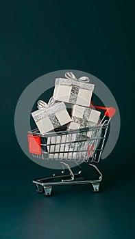 Black Friday shopping cart with gift boxes, dark background