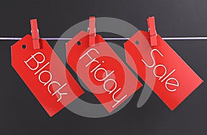 Black Friday shopping sale concept with message written across red ticket sale tags