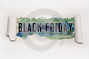 Black Friday text behind torn paper