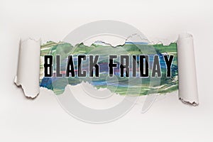Black Friday text behind torn paper photo