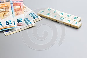 Black friday text and euro money on gray background