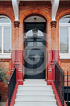 Black front door of a traditional house in London, UK