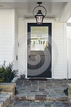 Black front door of white home