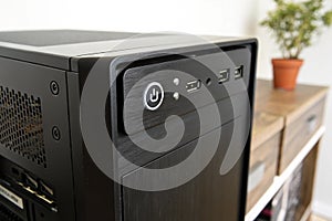 Black front panel of computer with power button on